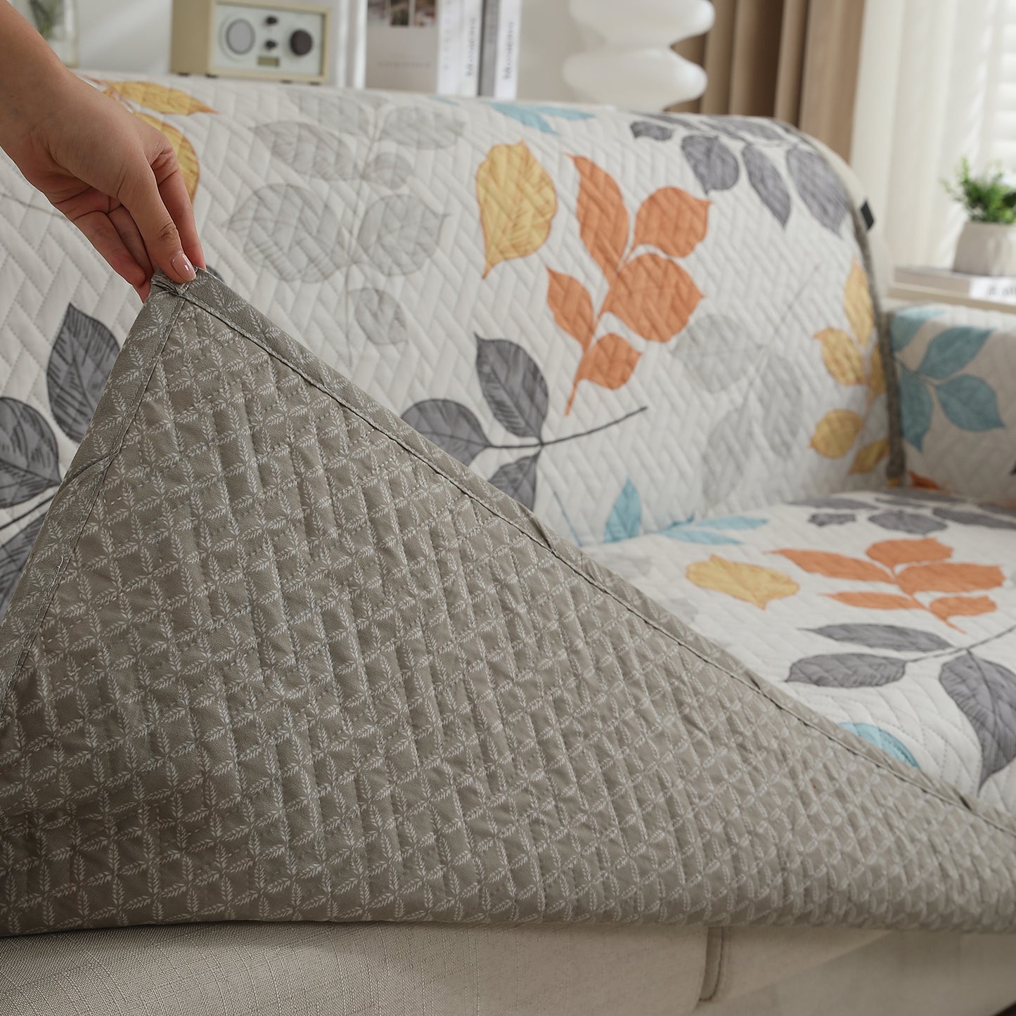 Multicolor Leaves Printed quilted sofa cover with non slip elastic strap