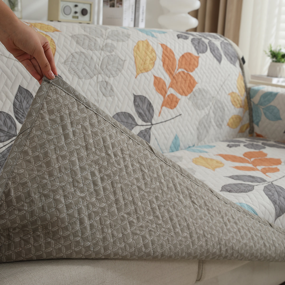 Multicolor Leaves Printed quilted sofa cover with non slip elastic strap